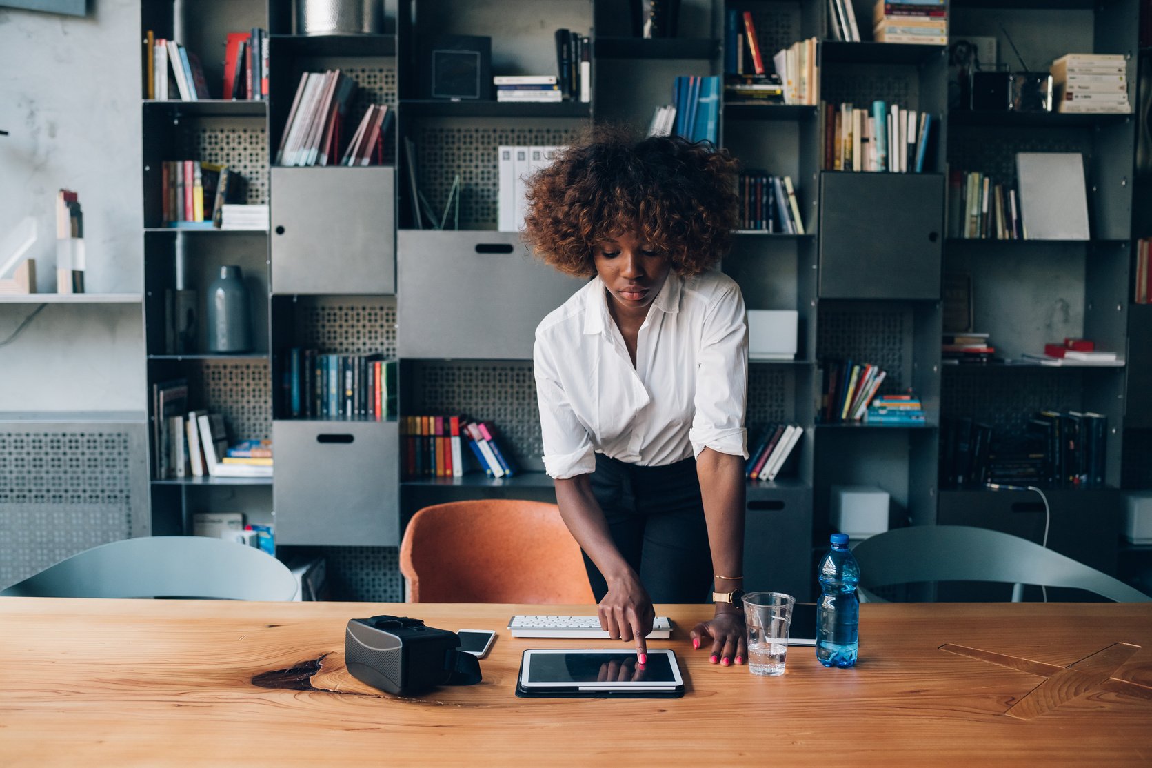 Young Black Woman Using Tablet in Modern Office